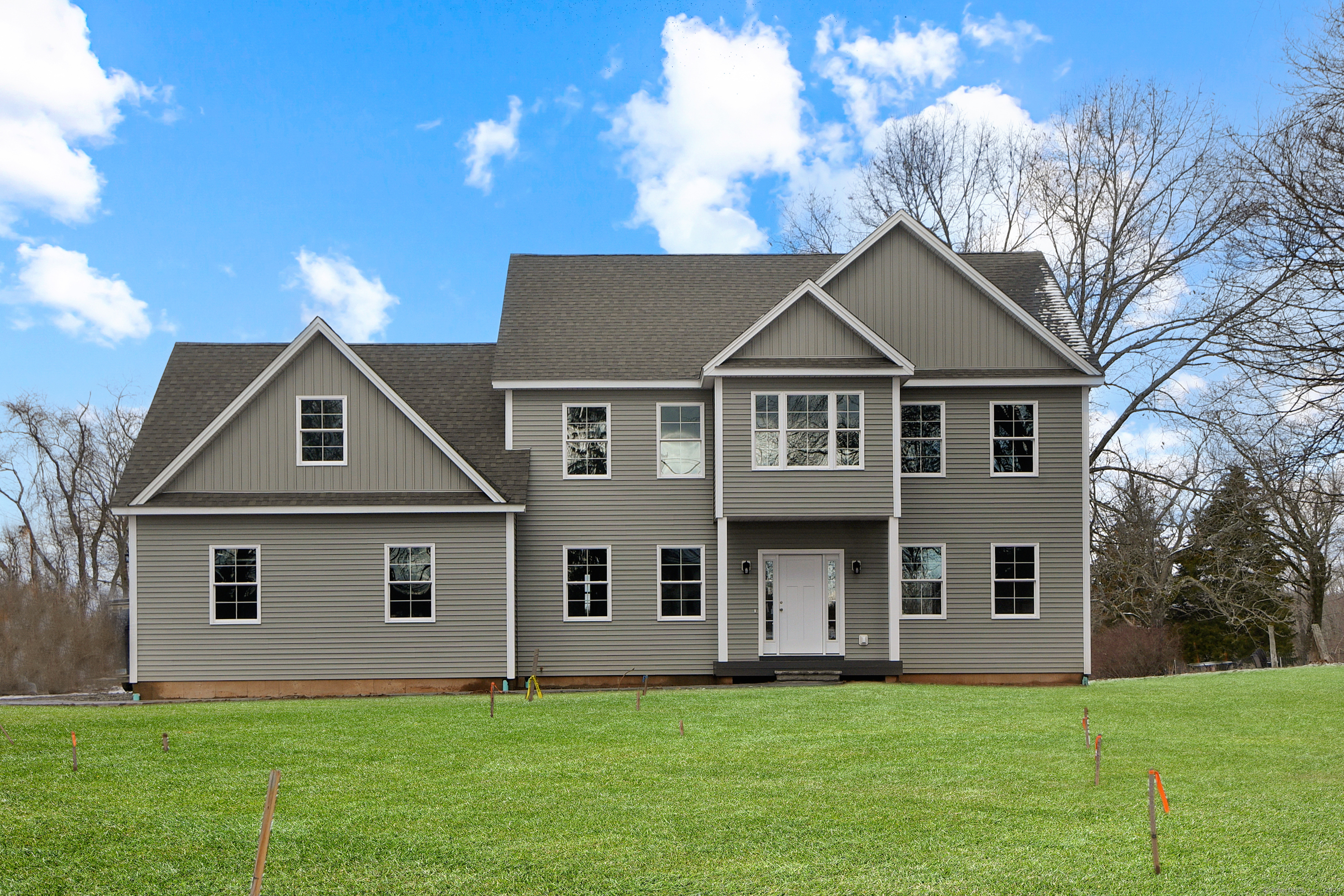 a front view of a house with a yard