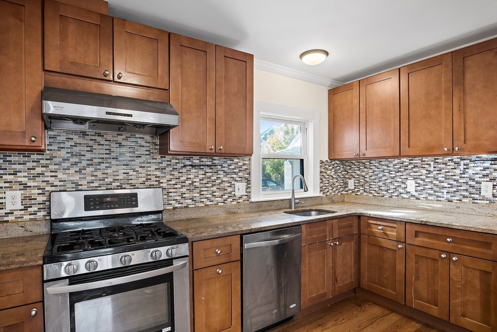 a kitchen with stainless steel appliances a stove sink and cabinets