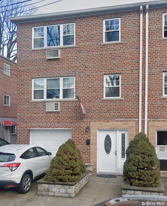 a couple of cars parked in front of a building