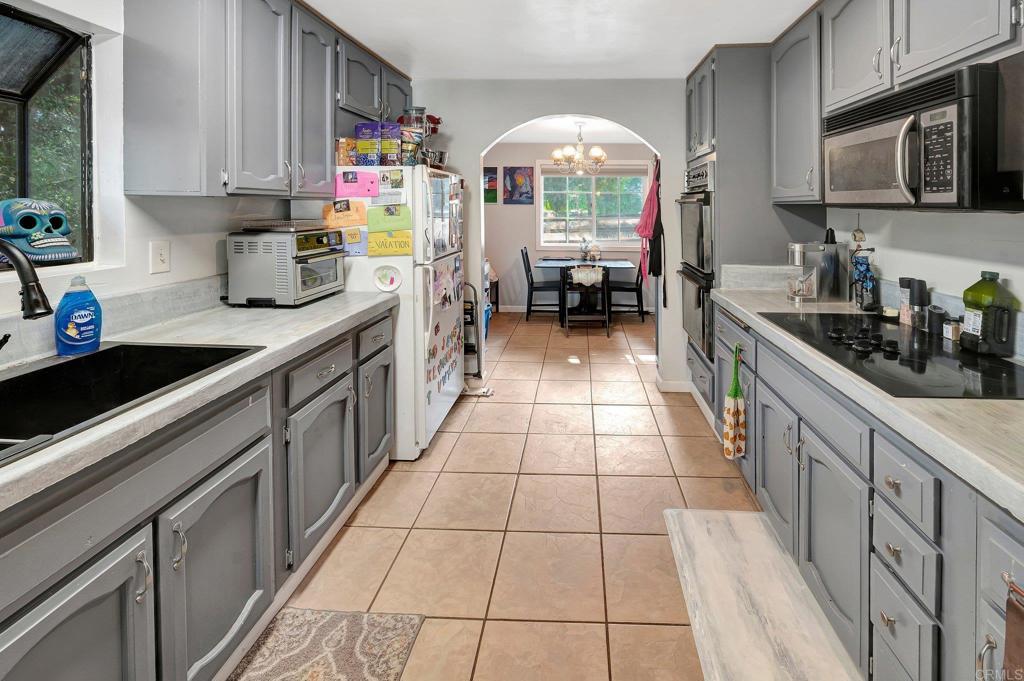 a kitchen with stainless steel appliances a sink stove and cabinets