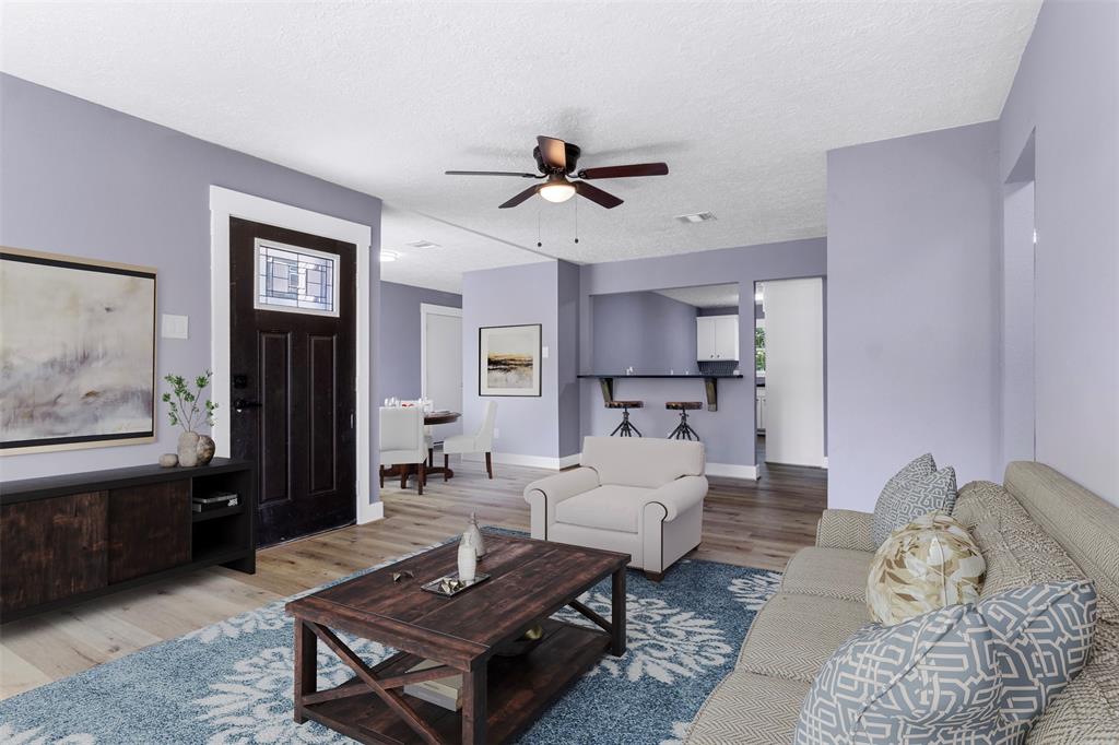 a living room with furniture and wooden floor