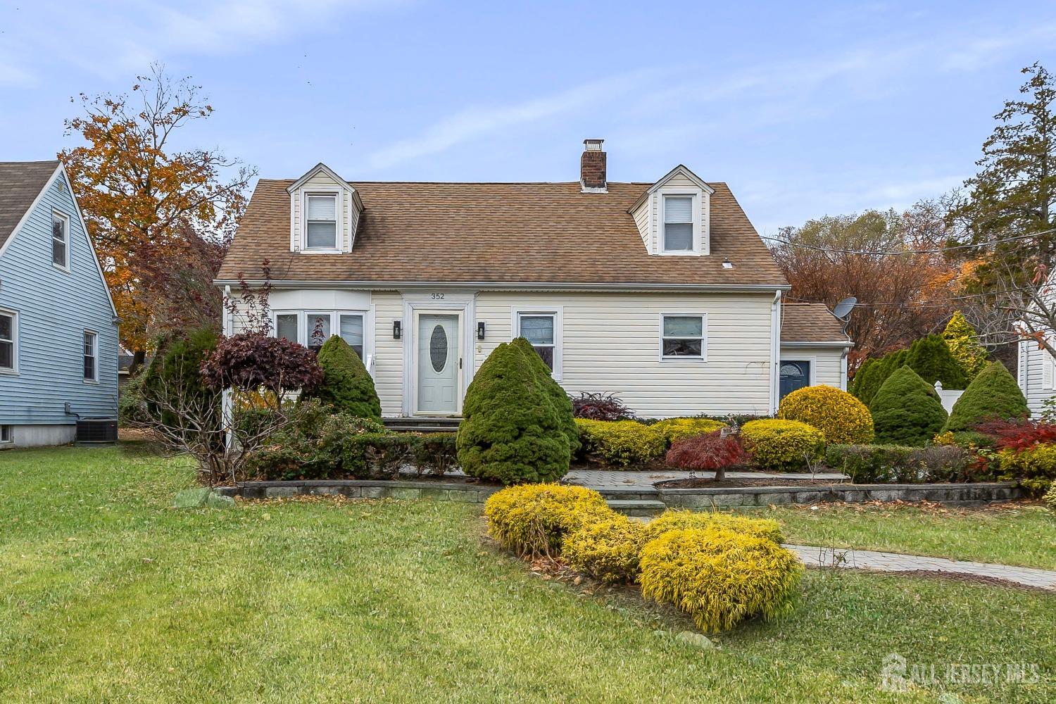 a front view of a house with garden