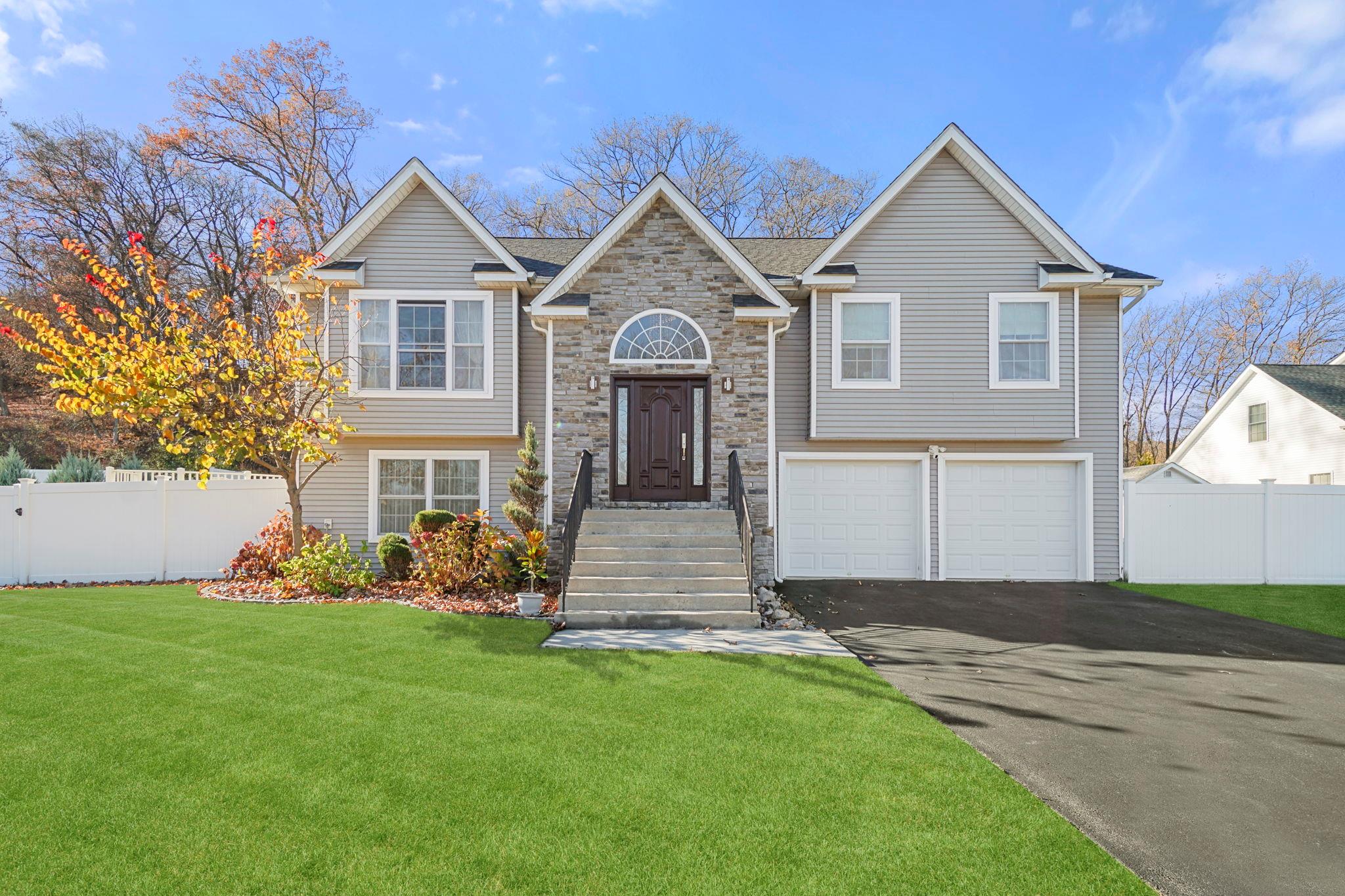 Bi-level home with a garage and a front yard