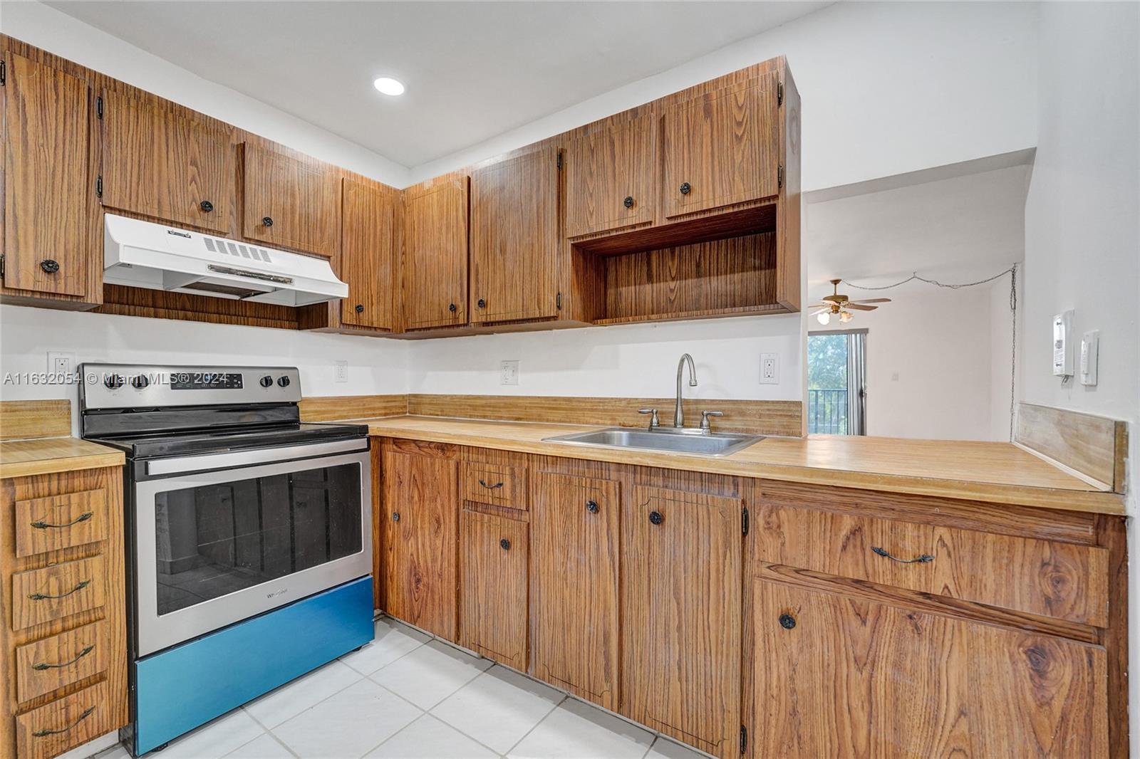 a kitchen with granite countertop cabinets stainless steel appliances and a sink