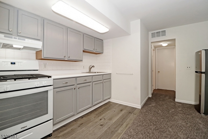 a kitchen with cabinets appliances and a counter space