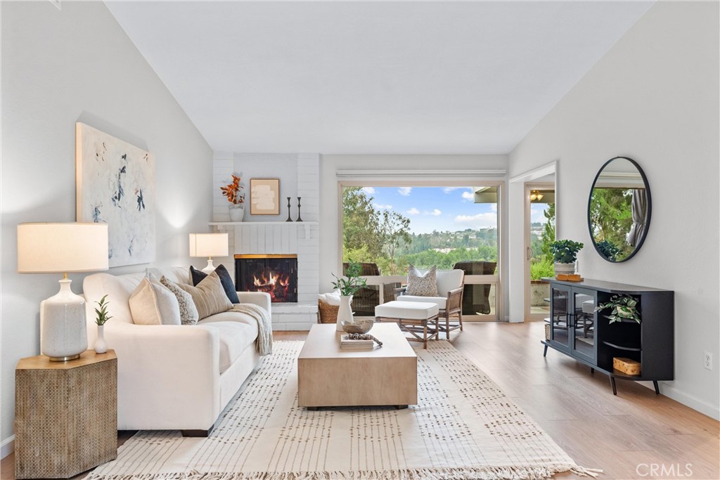 a living room with furniture a window and a fireplace