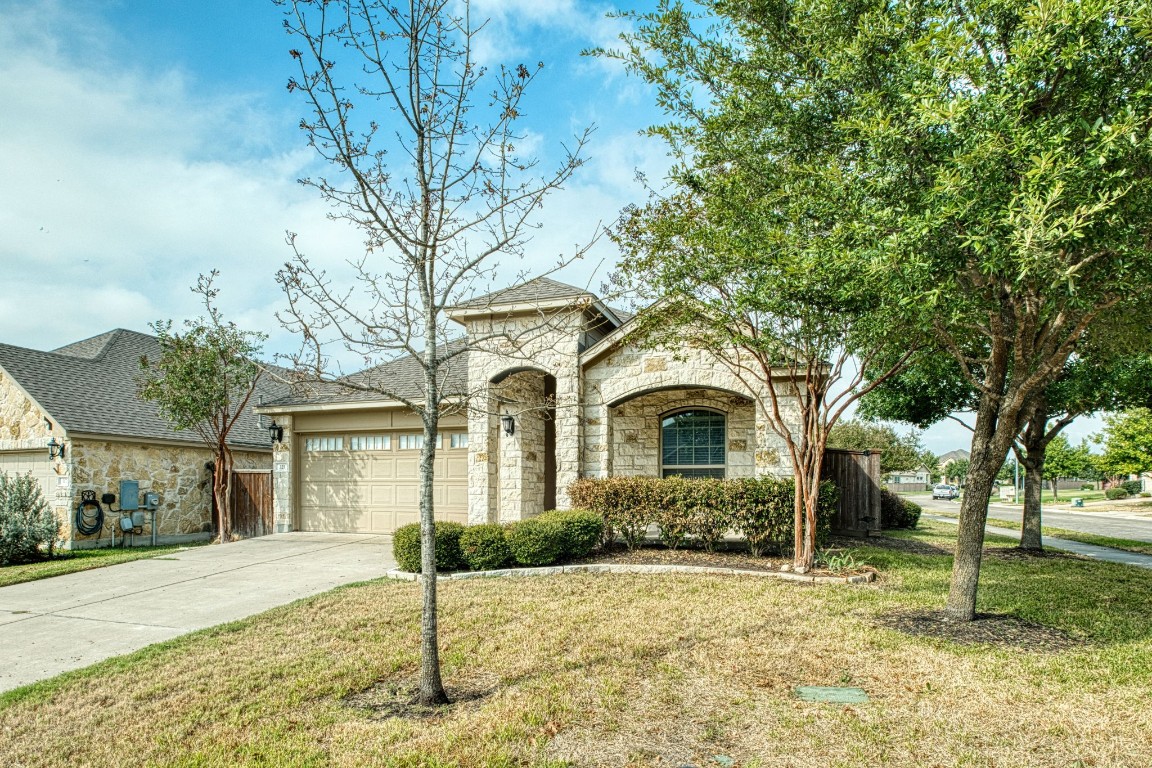 a front view of a house with a garden