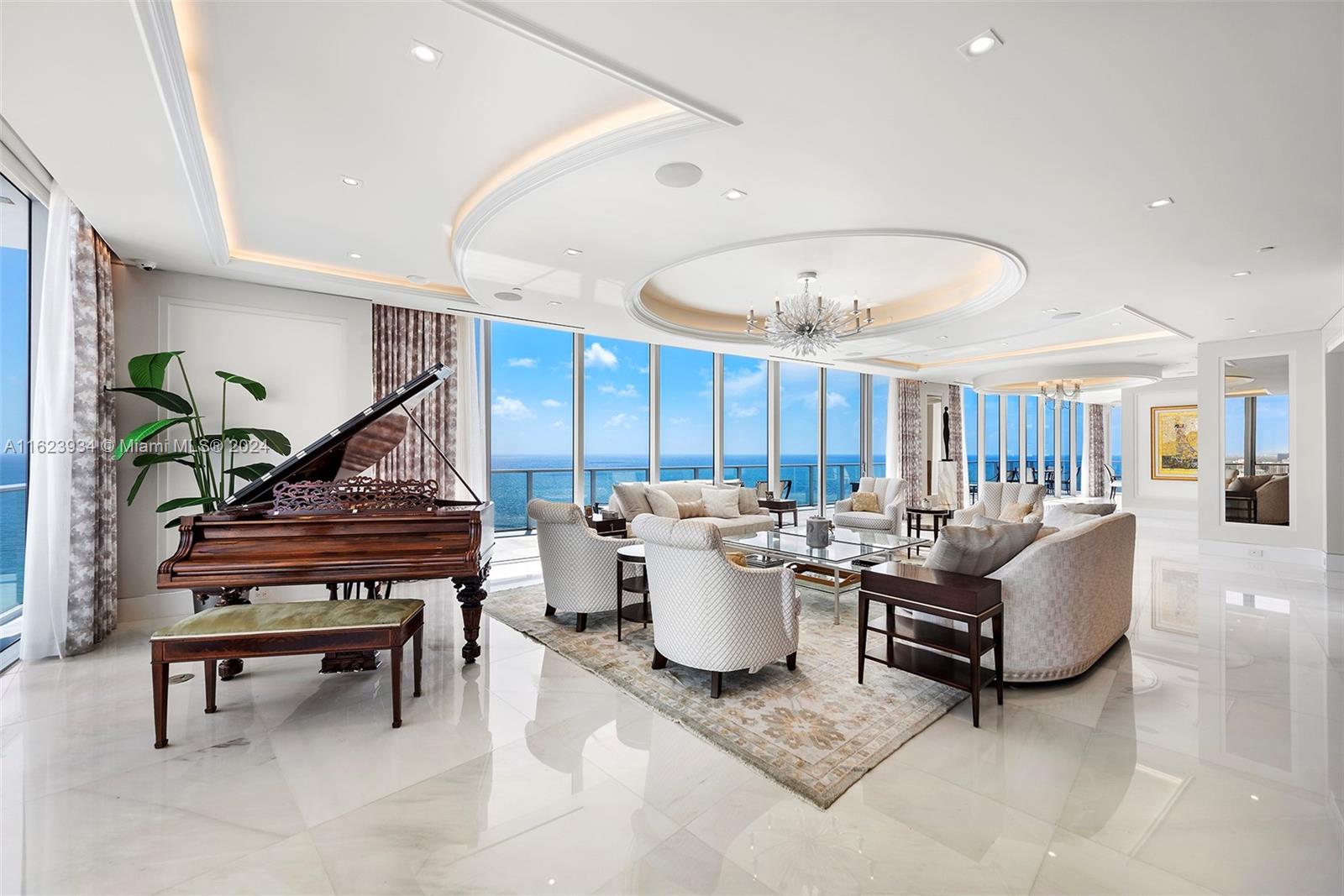 a living room with furniture a wooden floor and a chandelier