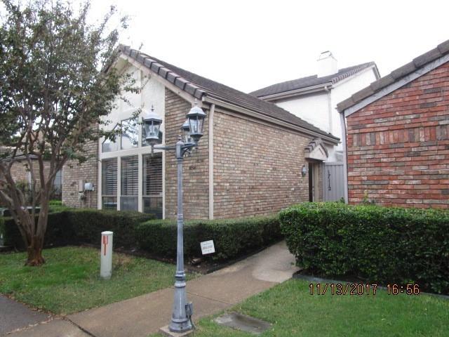 a front view of a house with garden and plants