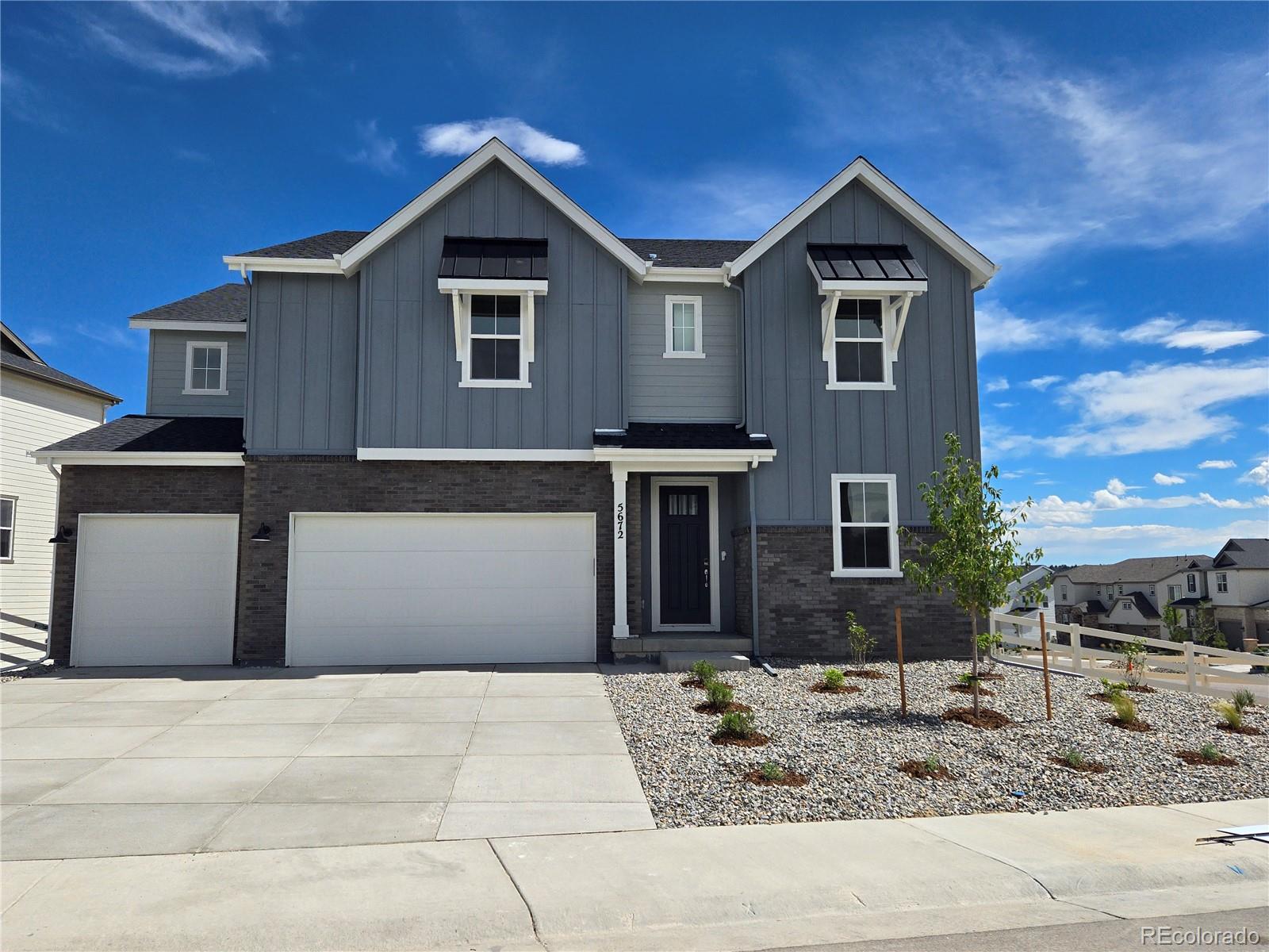 a front view of a house with garage