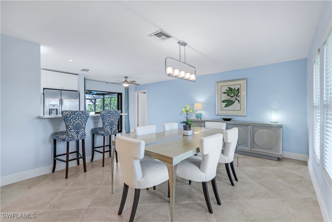 a view of a dining room with furniture and chandelier