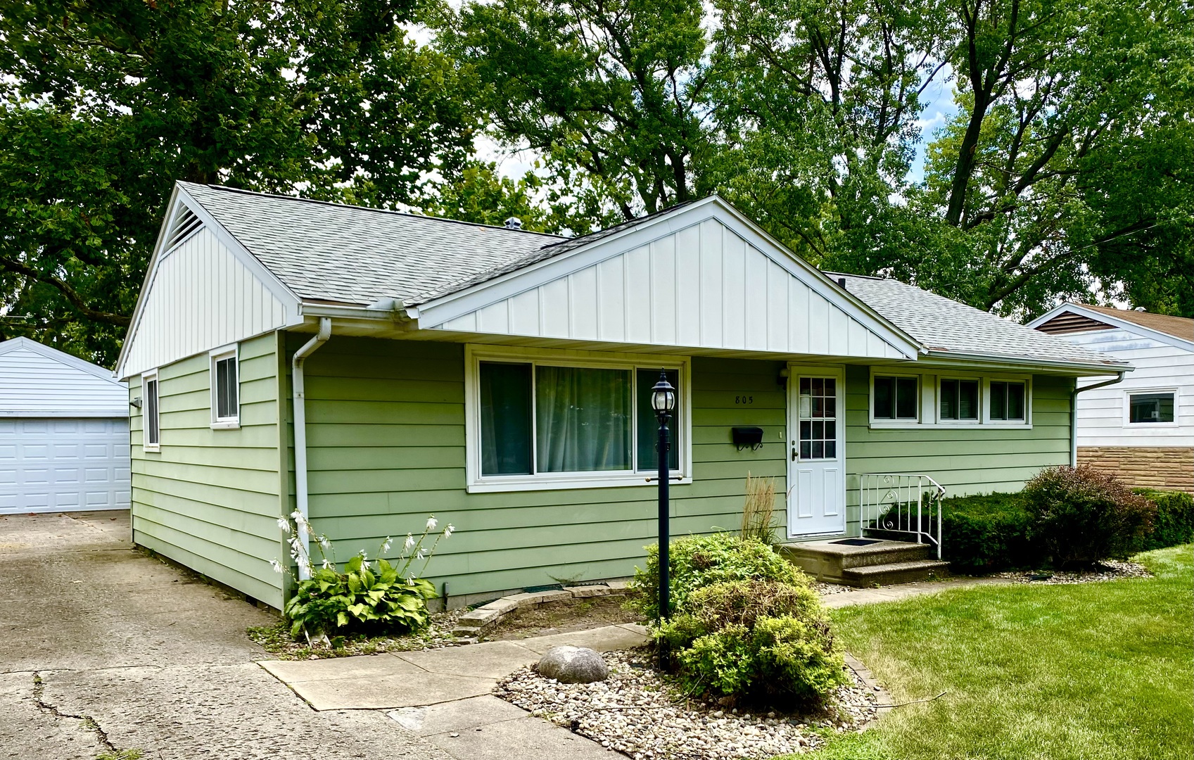 a front view of a house with a garden