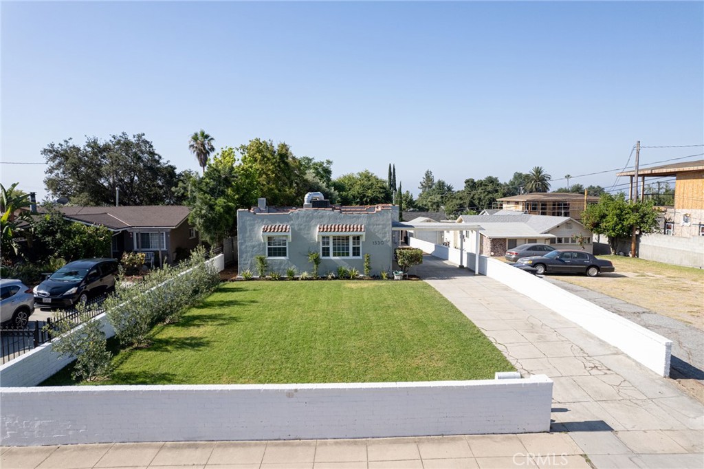 a view of house with outdoor space and sitting area