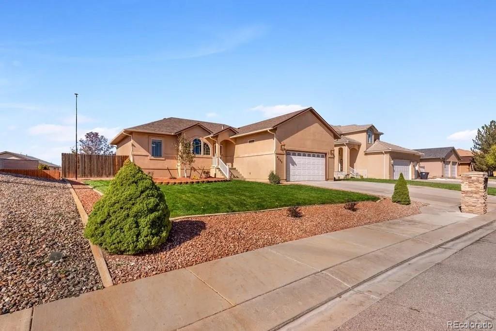 a front view of a house with a yard and garage