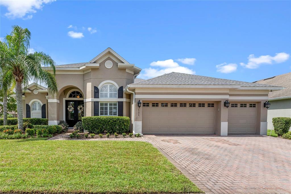 a front view of a house with a yard and garage