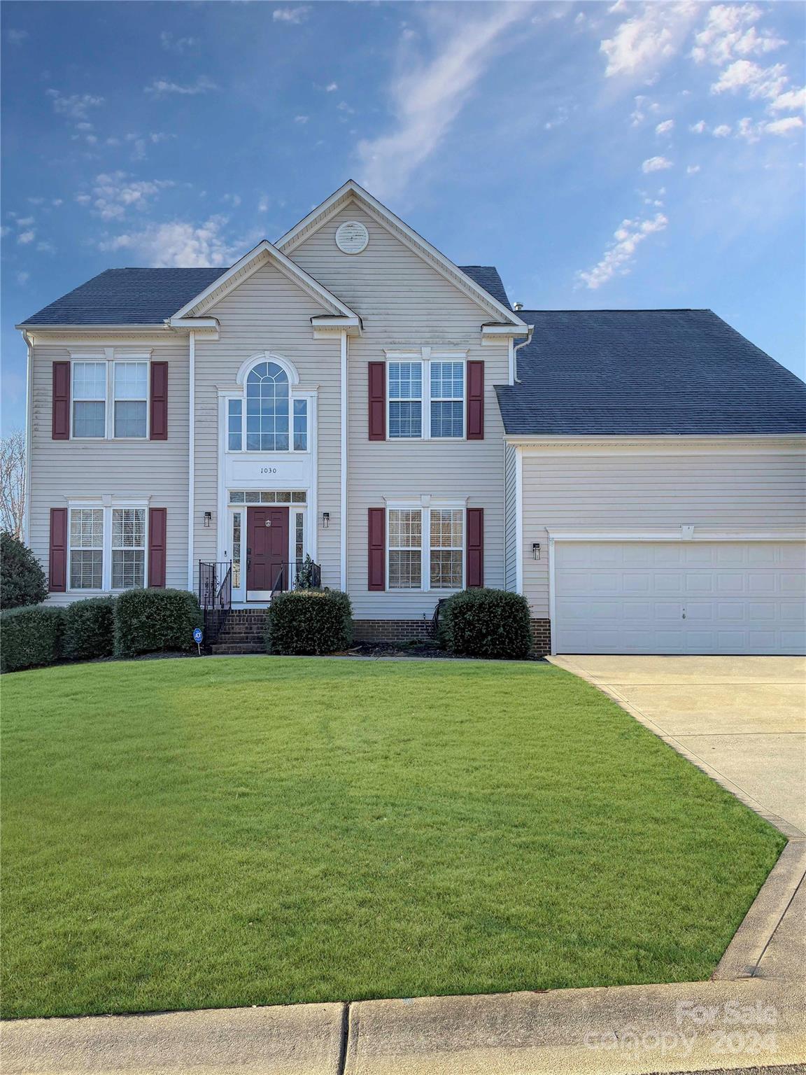 a front view of a house with a yard