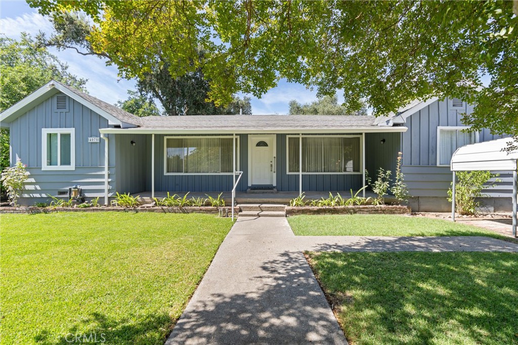 a front view of house with yard and green space