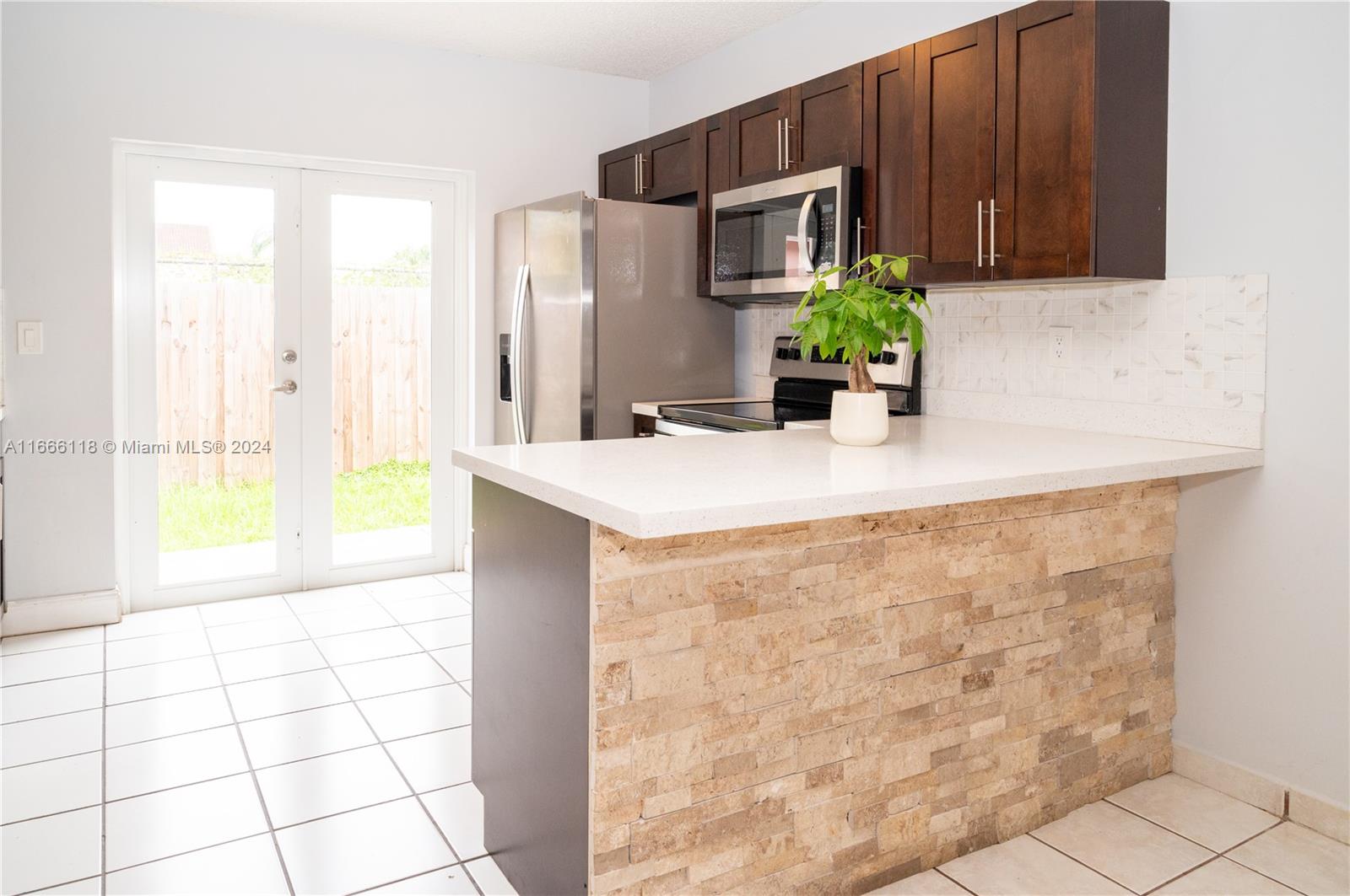 a kitchen with stainless steel appliances a counter top space and cabinets