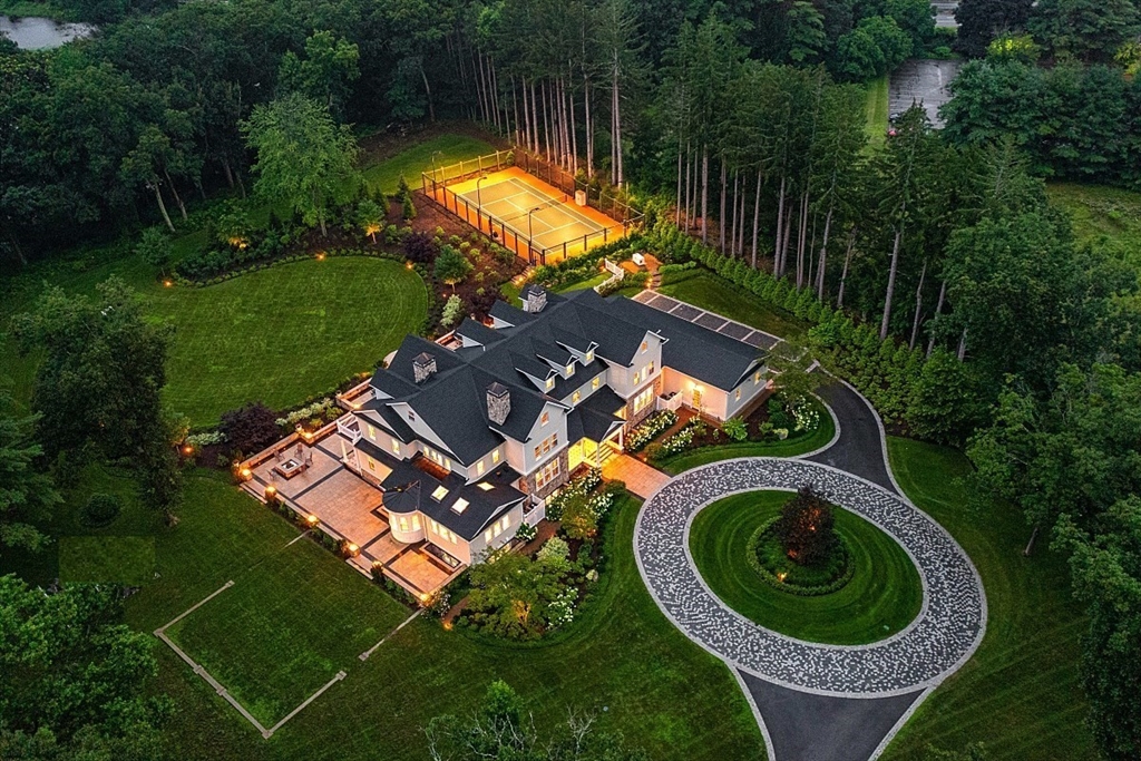 an aerial view of a house with a garden and swimming pool