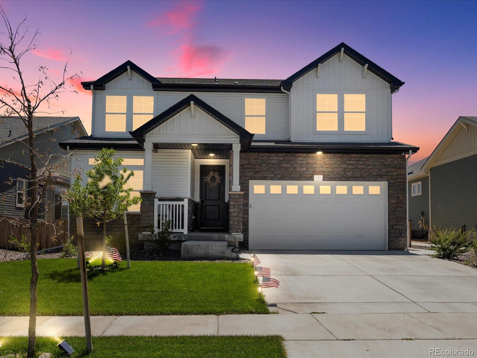 a front view of a house with a yard and garage