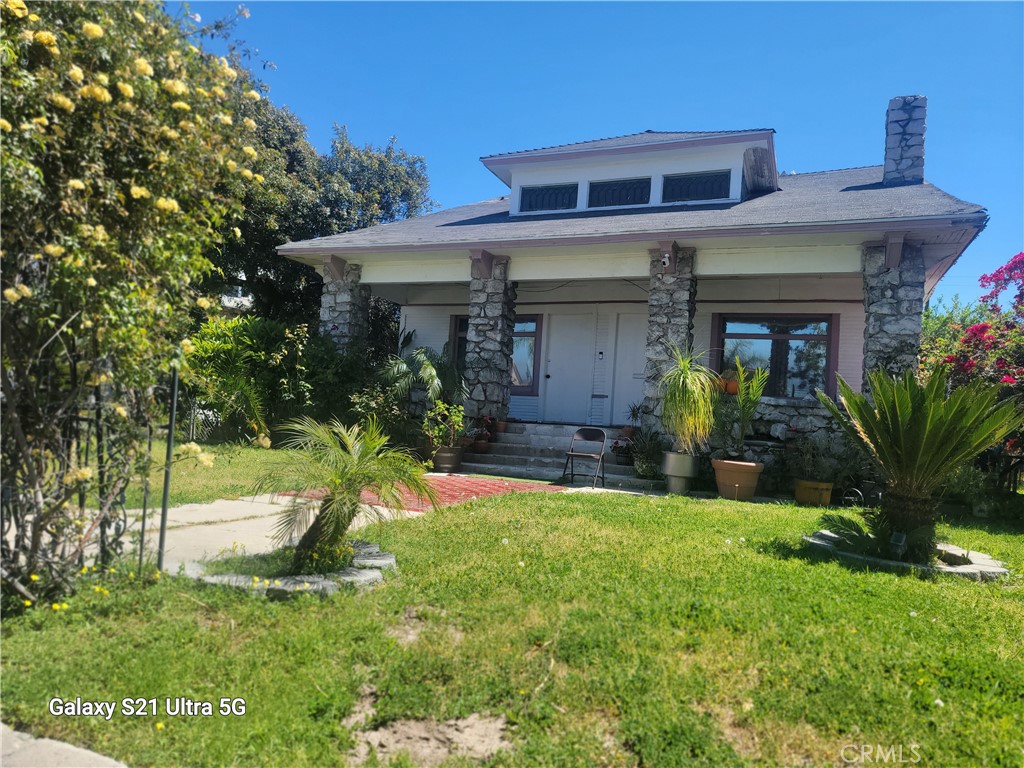 a view of a house with a yard porch and sitting area