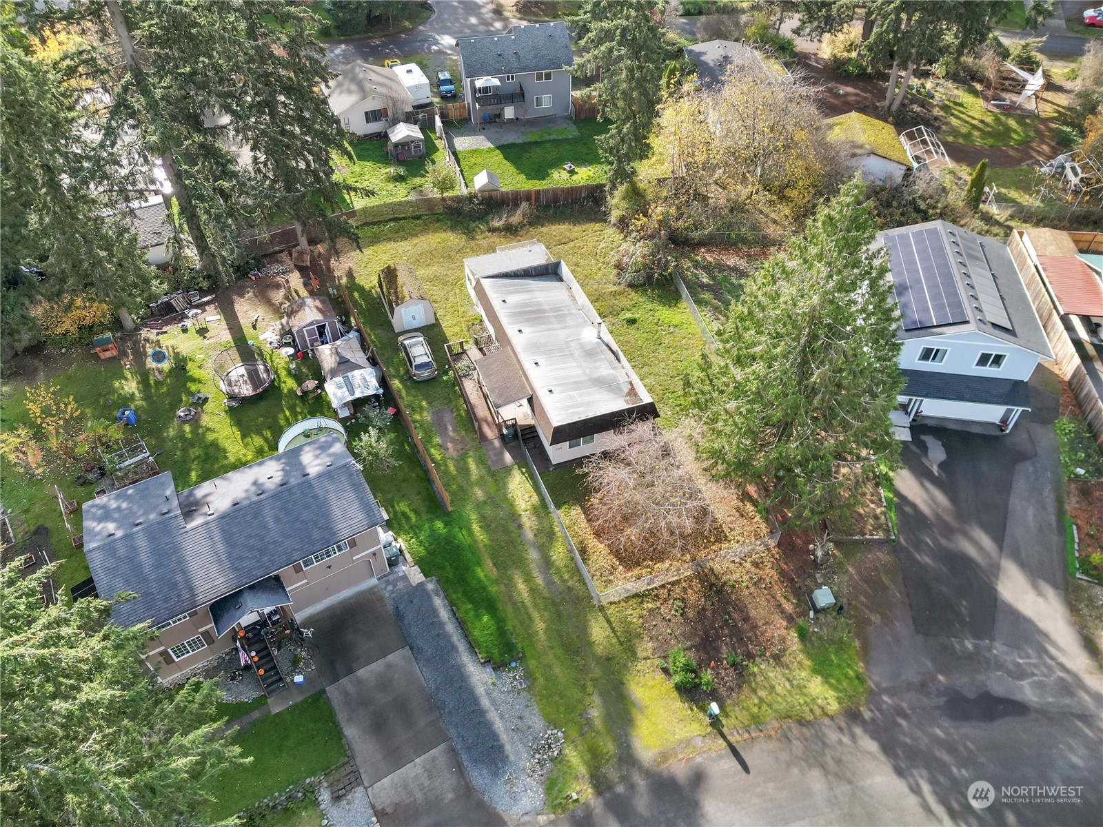 an aerial view of a house with a yard basket ball court and outdoor seating