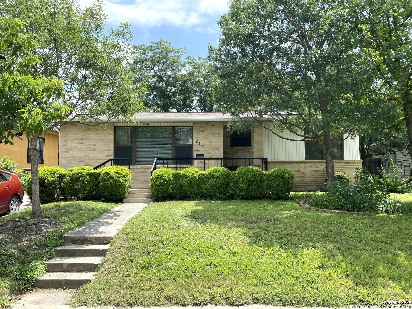 a front view of a house with garden