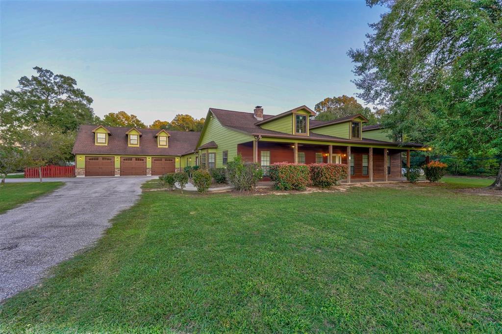 a front view of a house with a yard and lake view