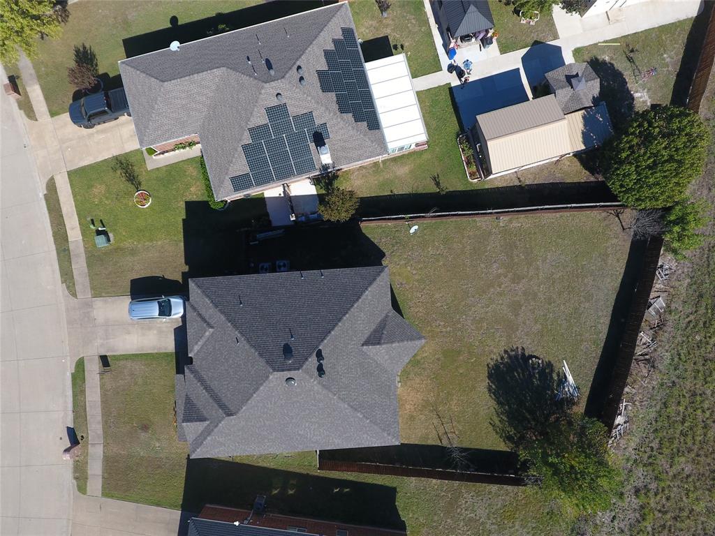 an aerial view of a house with a yard