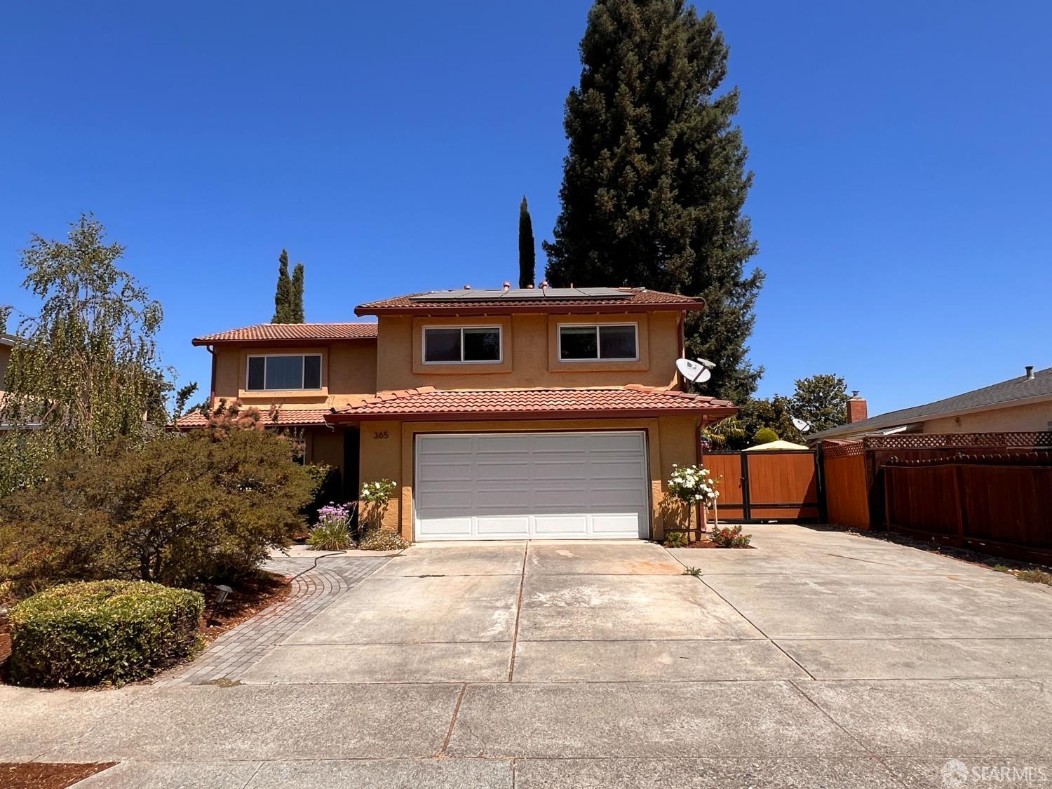 a view of a house with a yard and a garage