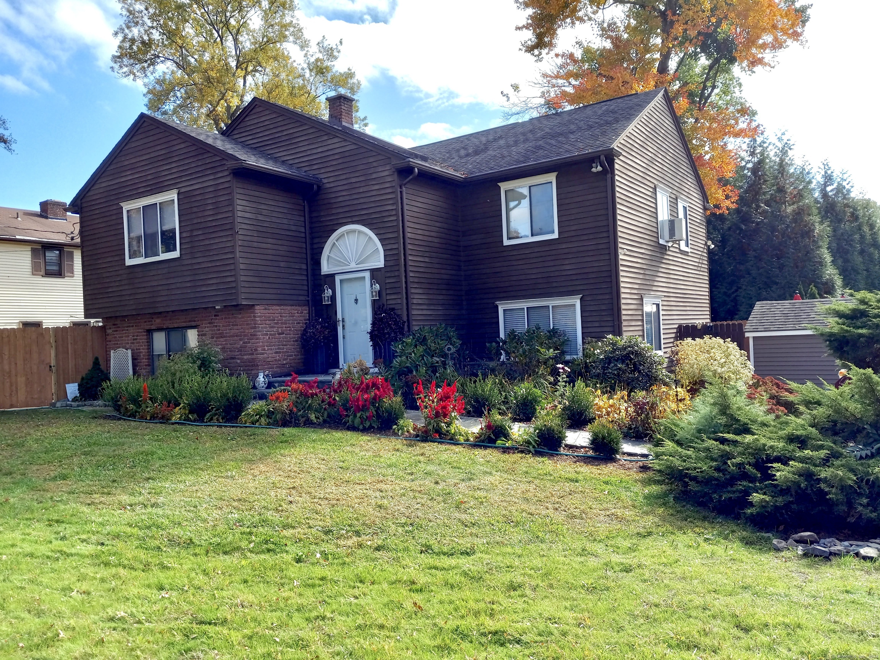 a front view of house with yard and outdoor seating