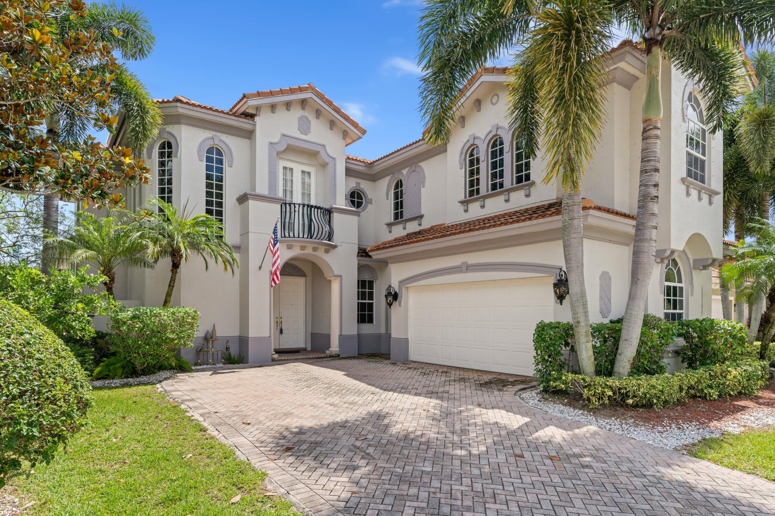 a front view of a house with a yard and a garage