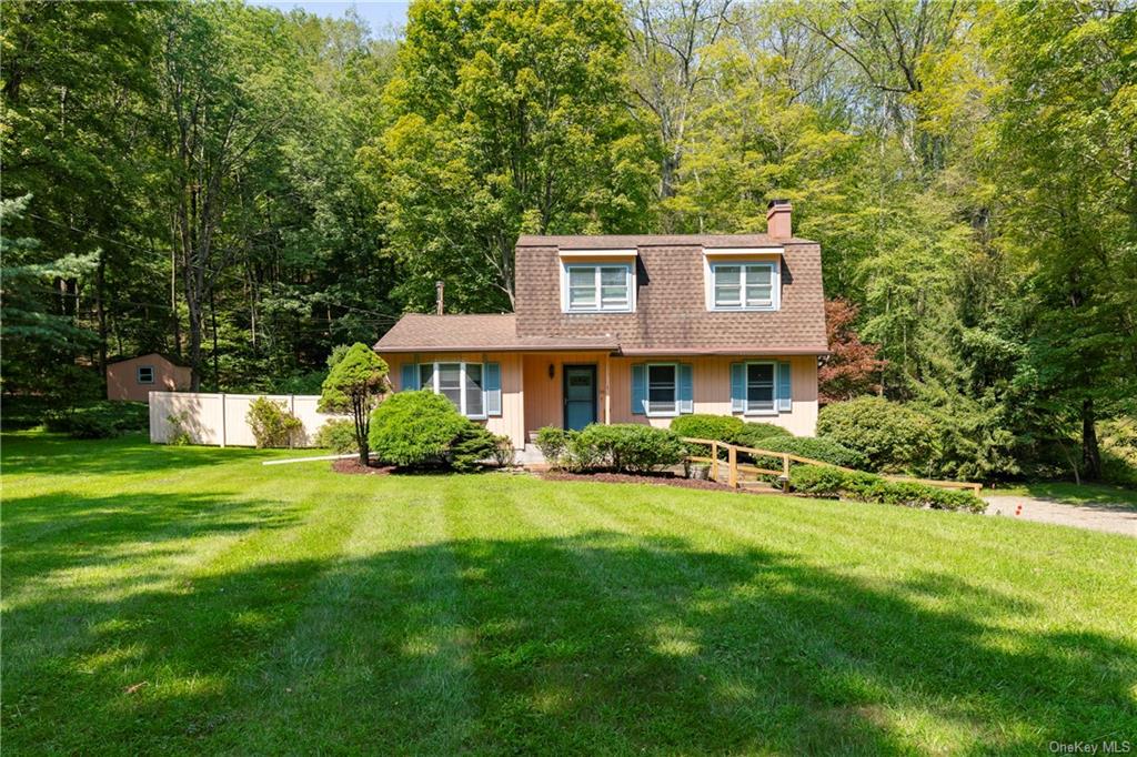 a view of a house with a yard patio and a table and chairs