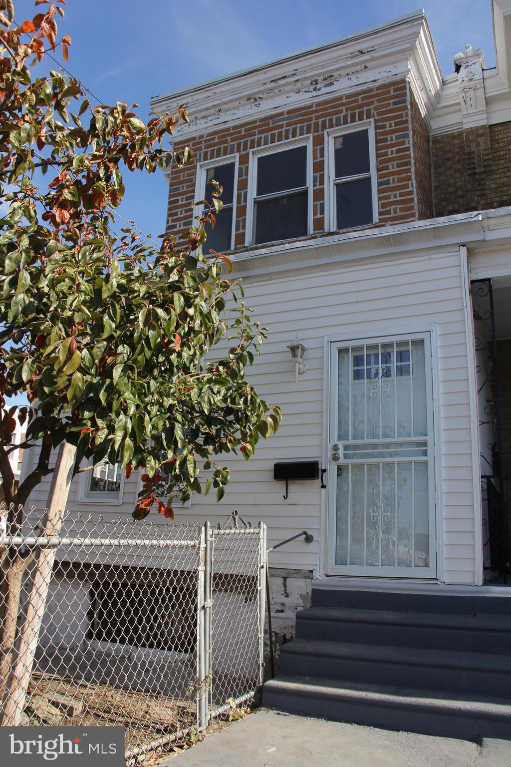 a view of a house with a window and wooden fence