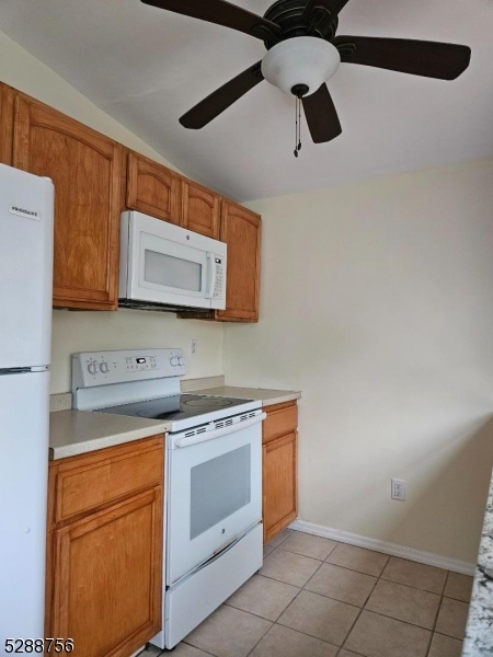 a kitchen with a stove cabinets and microwave