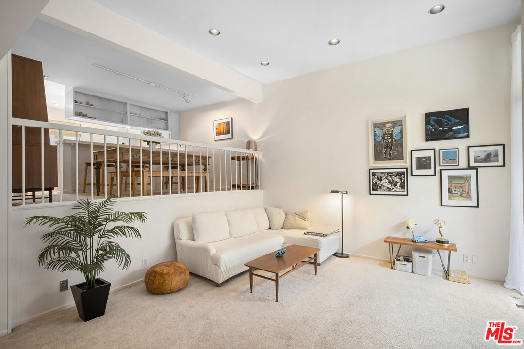 a living room with furniture and flowers