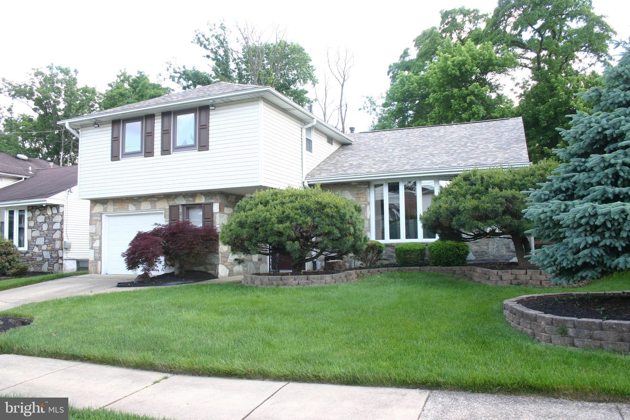 a view of a house with a yard and sitting area