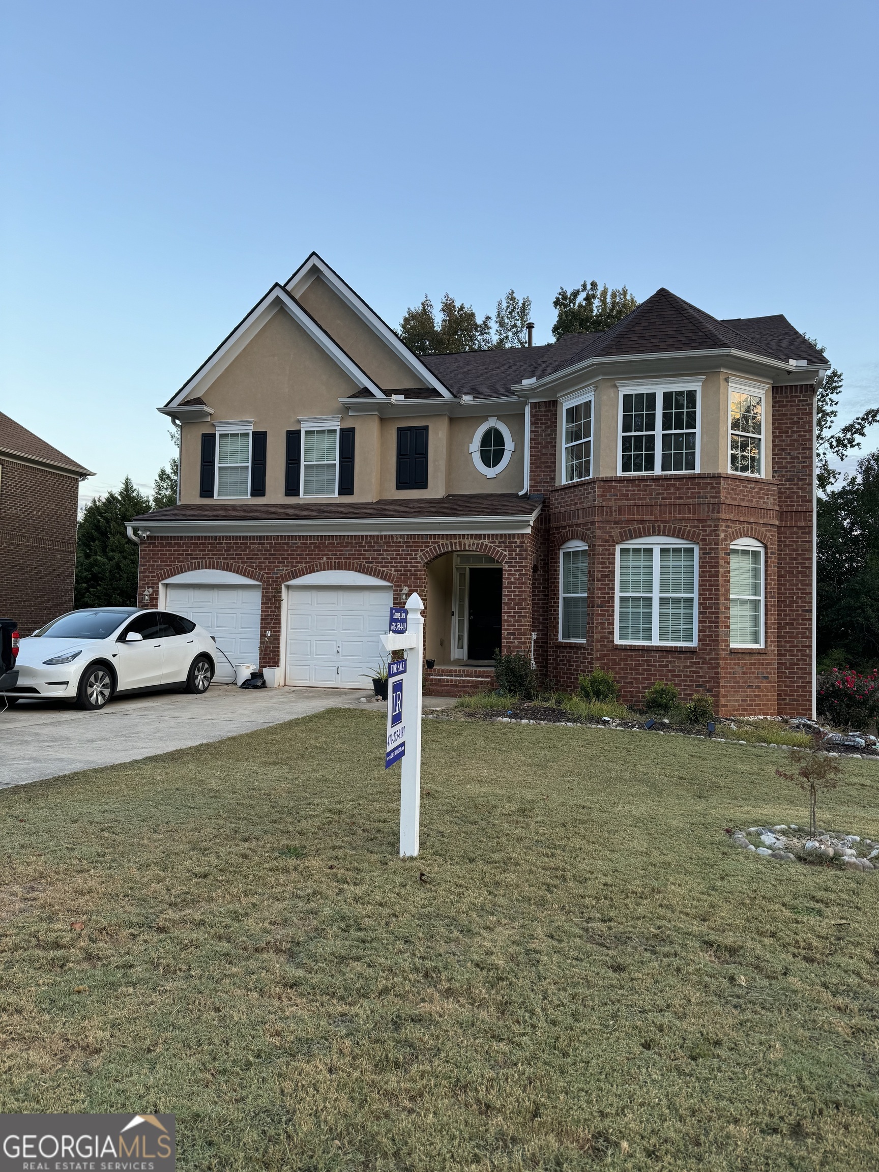 a front view of a house with a yard