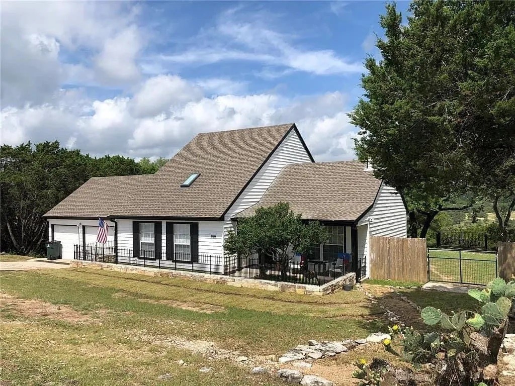 a view of a house with swimming pool and a yard