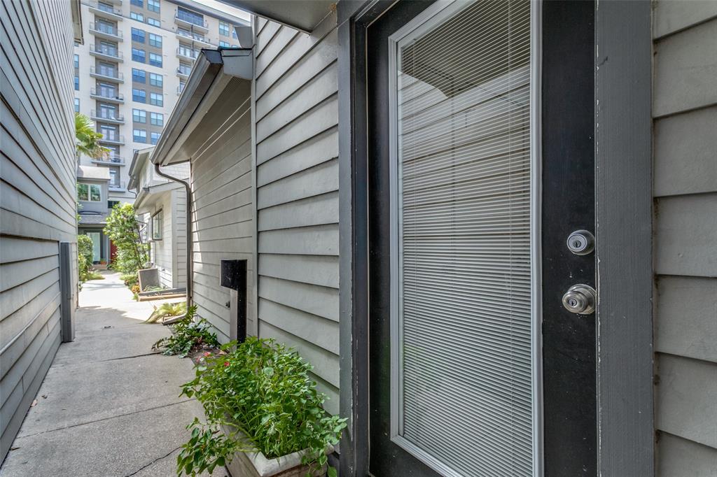 a view of house with wooden door and outdoor seating