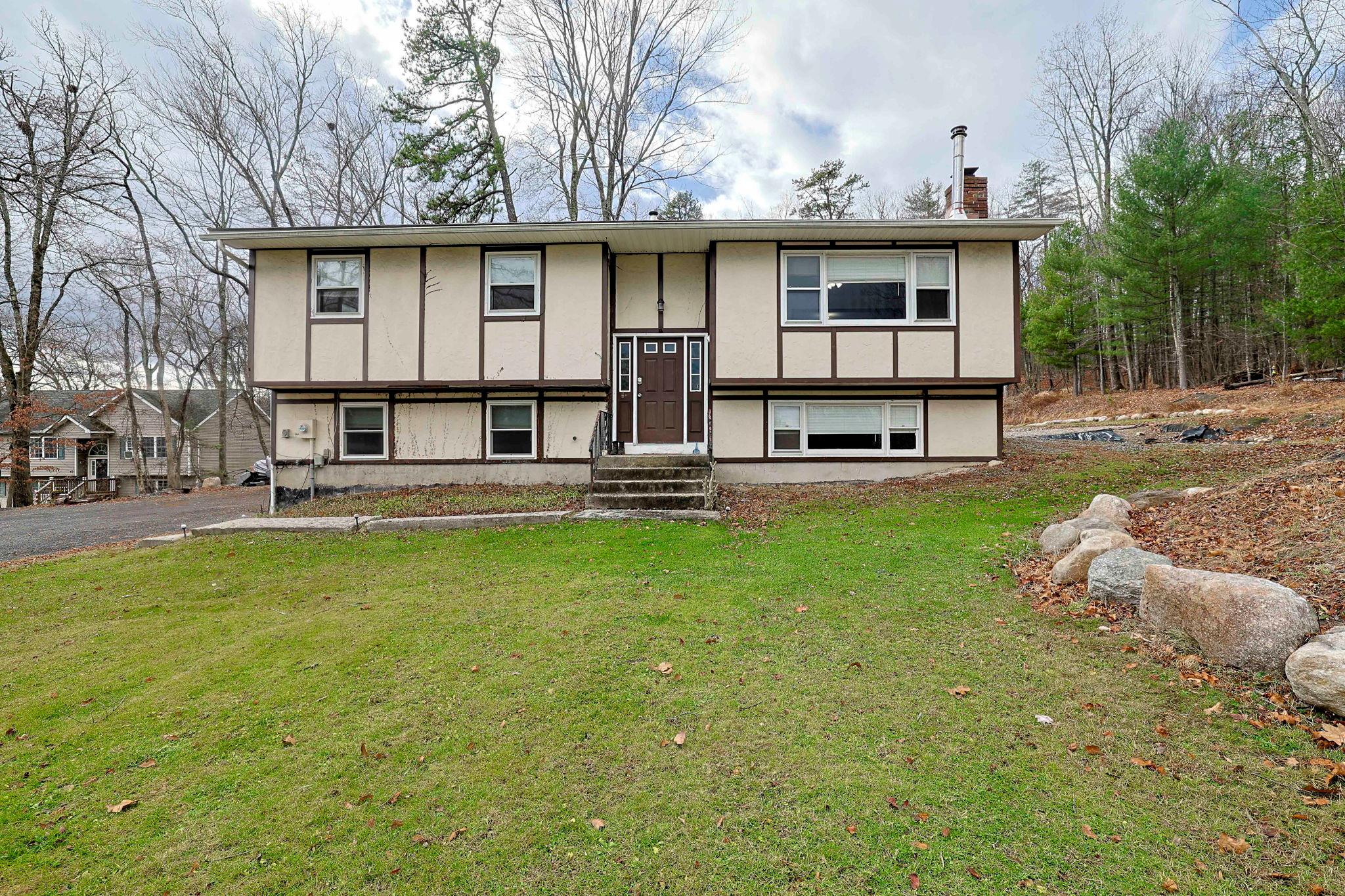 Split foyer home featuring a front lawn