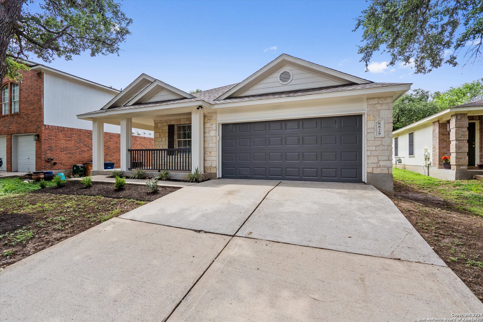 a front view of a house with a yard and garage