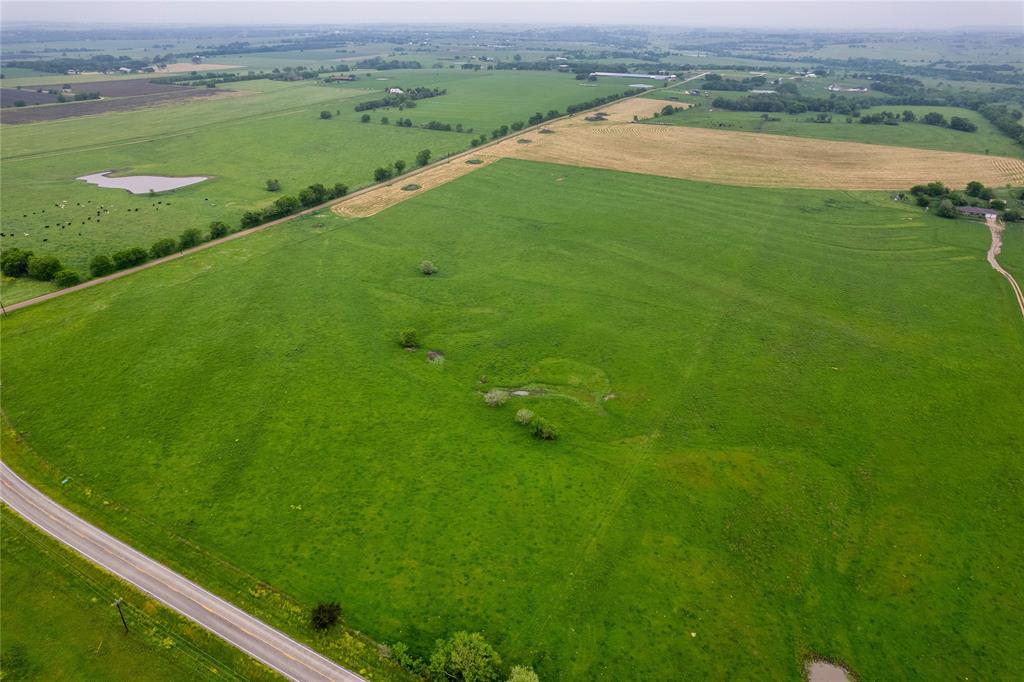 a view of a field with an ocean