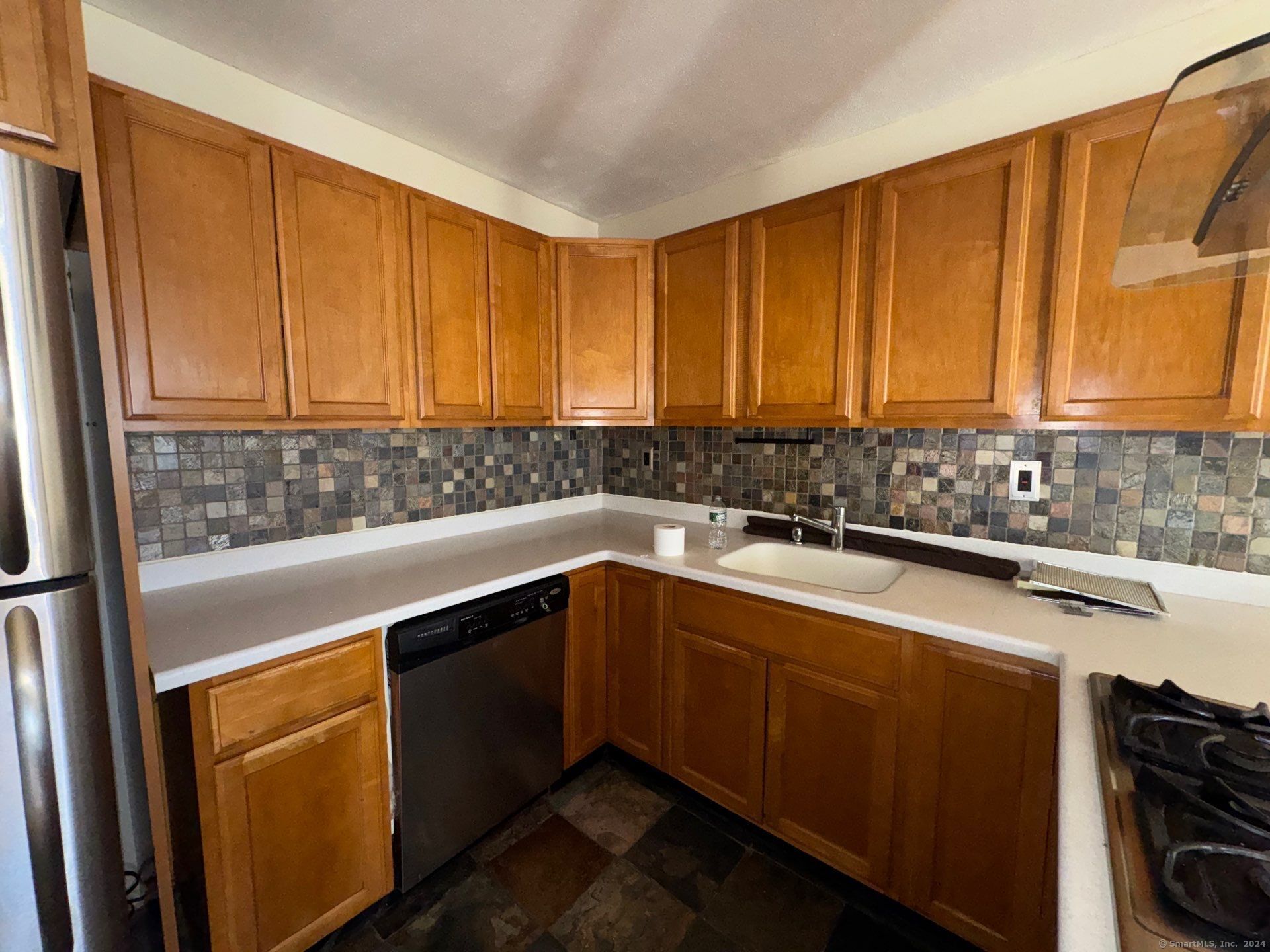 a kitchen with a sink cabinets and window