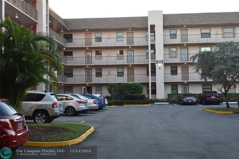 a front view of a residential apartment building with a yard