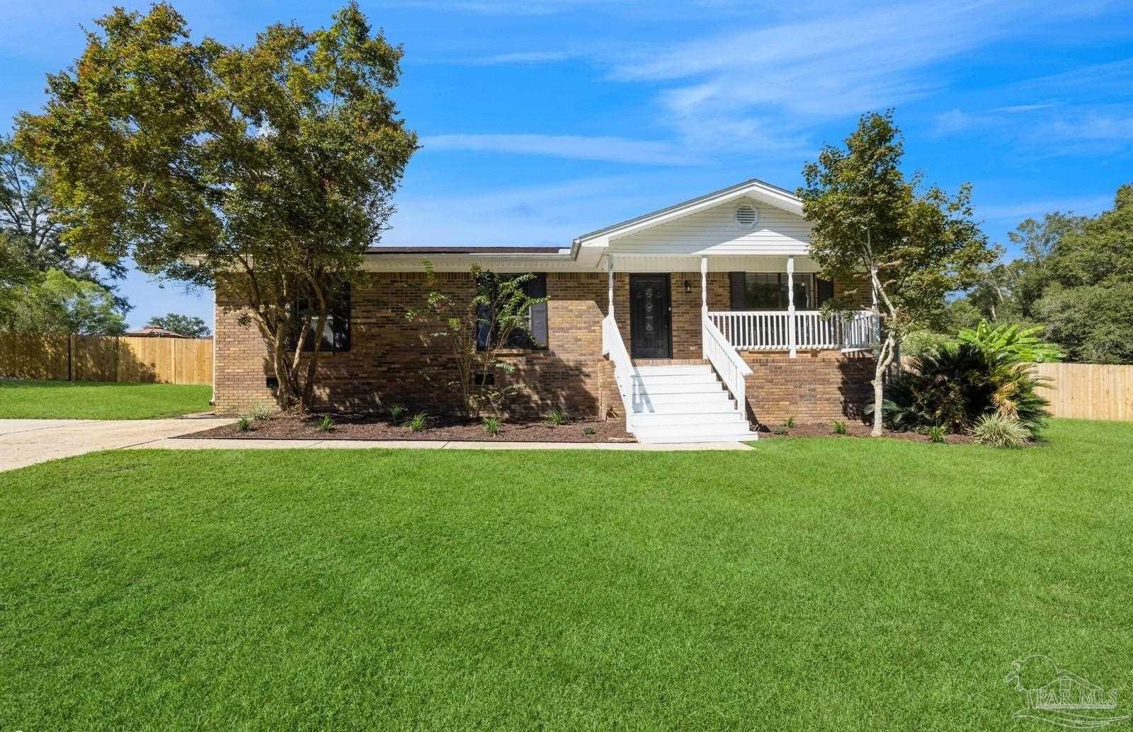 a view of a house with backyard sitting area and garden