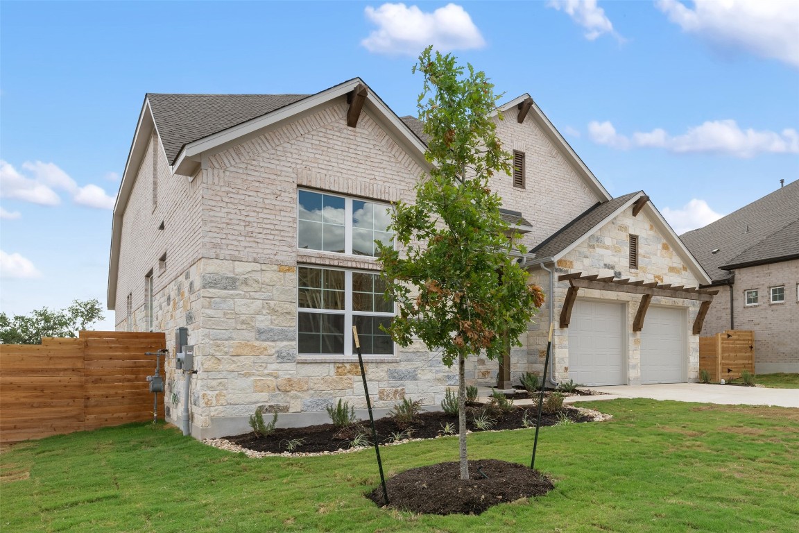 a front view of a house with a garden