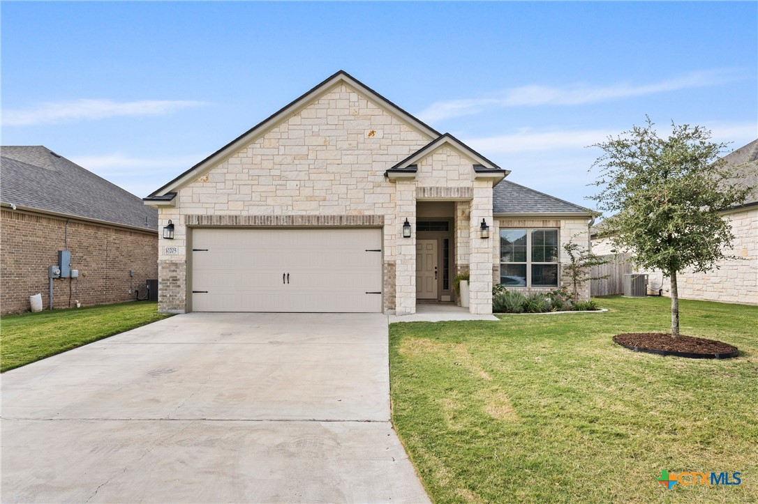 a view of a house with a yard and garage