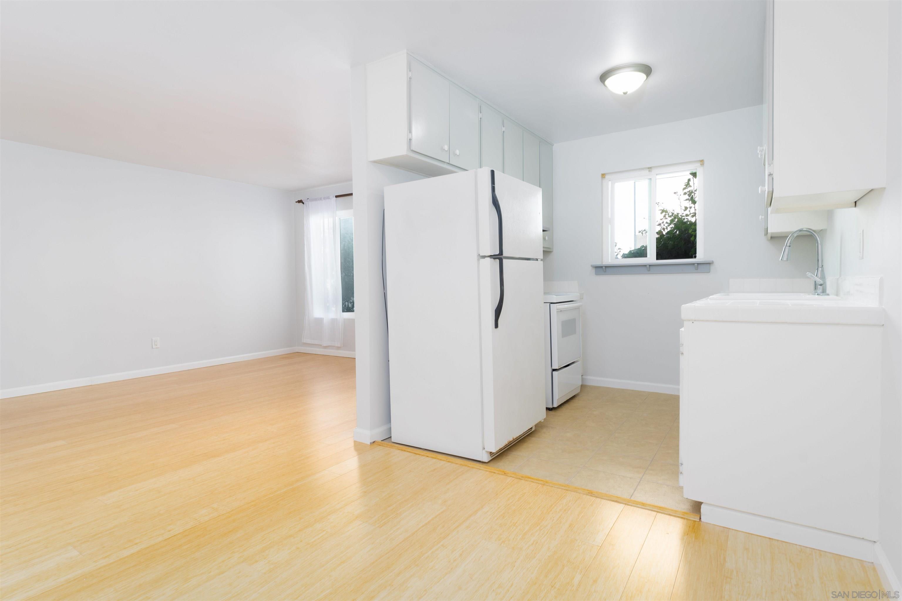 a view of a kitchen with a sink dishwasher and a refrigerator