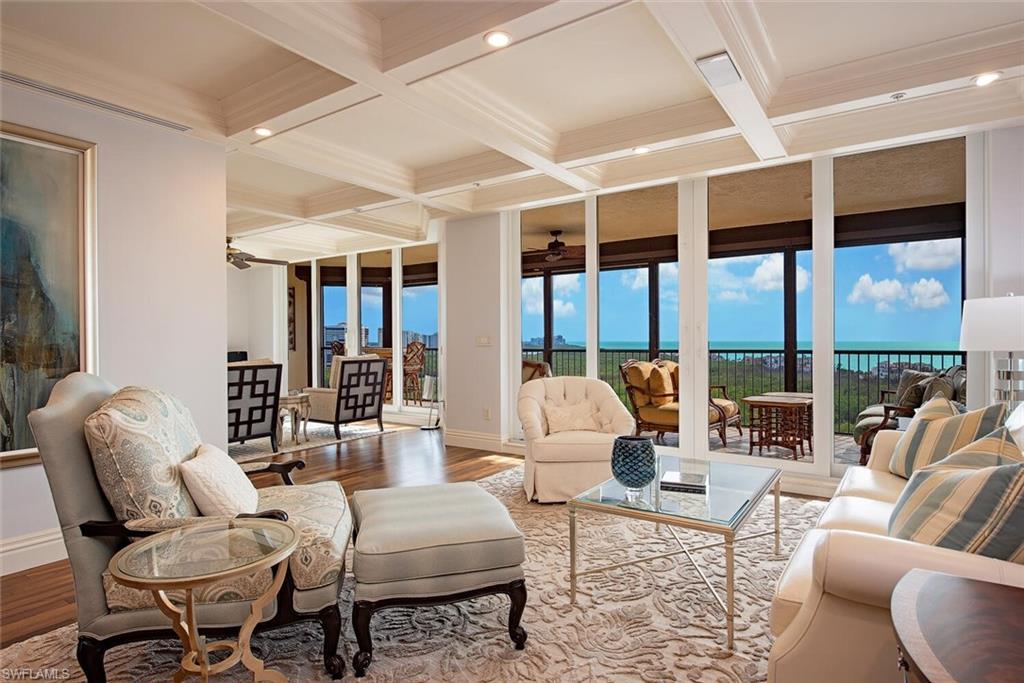 a living room with furniture and large windows